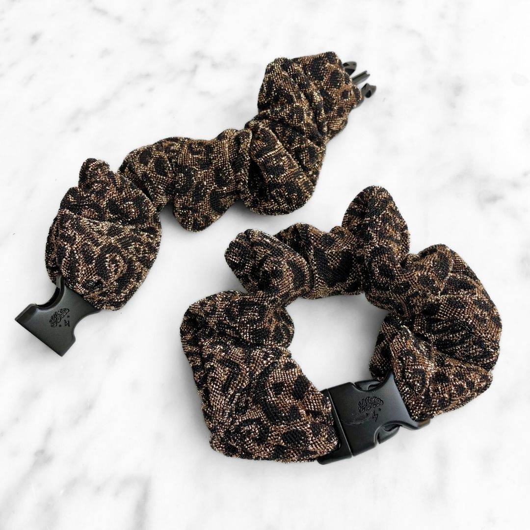 Best hair tie elastics and scrunchie hair accessories for snag-free, pull-free, rip-free, hair. Smooth, effortless hair ties and hair scrunchies for athletes, active moms, fitness, & sports. Spotted Spark - Sparkly Leopard Print Buckle Scrunchie - No Snagging, No Tangles