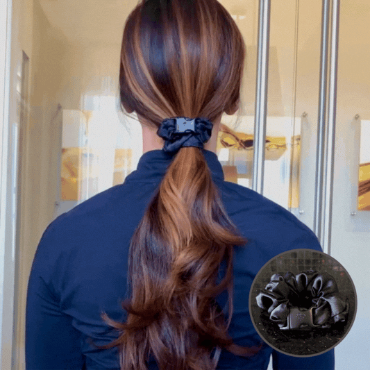 Woman seen from behind with a ponytail held by a dark Buckle Scrunchie
