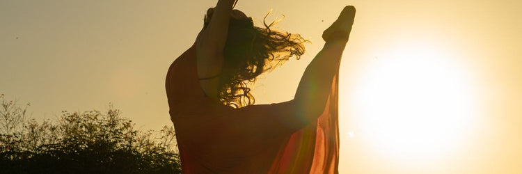 Irish Dance Scrunchies & Hair Ties: Dancer backlit at sunset mid turn with her hair flying