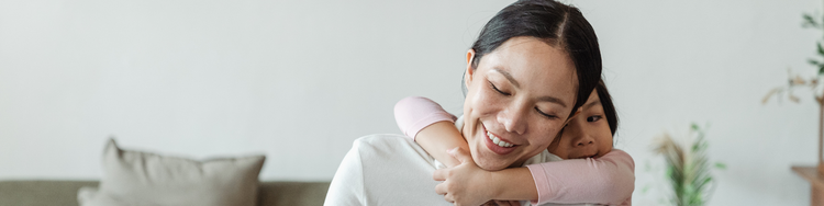 Gifts for caregivers: Mother holding her baby indoors