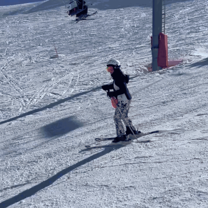 Snowboarding Scrunchies & Hair Ties: Skier on a snowy slope with her hair tied back