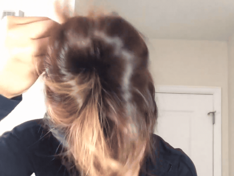 Gifts for doctors: Woman with dark hair putting it up with a Buckle Scrunchie