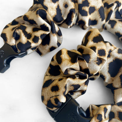 Best zero tangle no pull hair tie elastics and scrunchie hair accessories for snag-free, pull-free, rip-free, hair. Smooth, effortless hair ties and hair scrunchies for athletes, active moms, fitness, & sports. Prowl Leopard Print Buckle Scrunchie - No Snagging, No Tangles