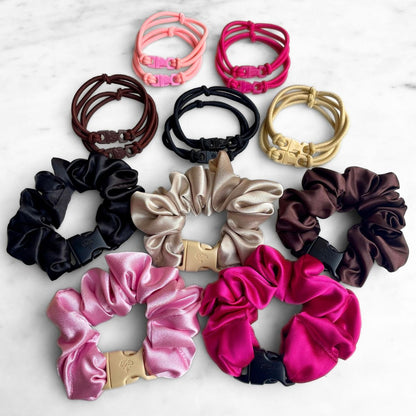 Best Sellers Gift Set: Buckle Hair Ties in pairs of Baby Pink, Hot Pink, Chocolate Brown, Industrial Black and Champagne Blonde above five satin Buckle Scrunchies