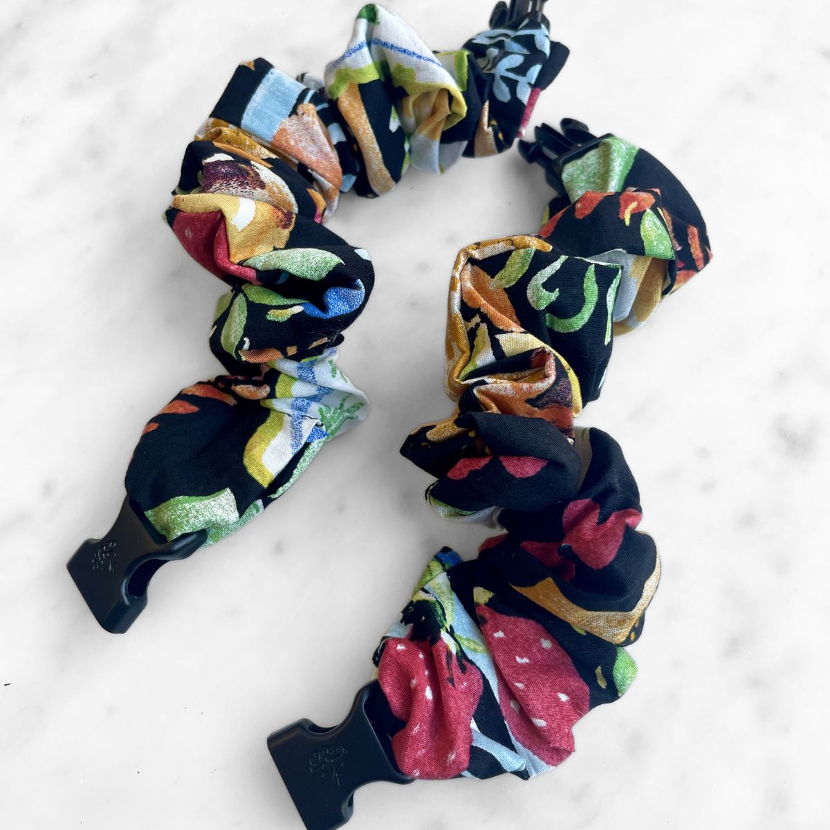 Best zero tangle no pull hair tie elastics and scrunchie hair accessories for snag-free, pull-free, rip-free, hair. Smooth, effortless hair ties and hair scrunchies for athletes, active moms, fitness, & sports. Farmers Market Print Buckle Scrunchie - No Snagging, No Tangles