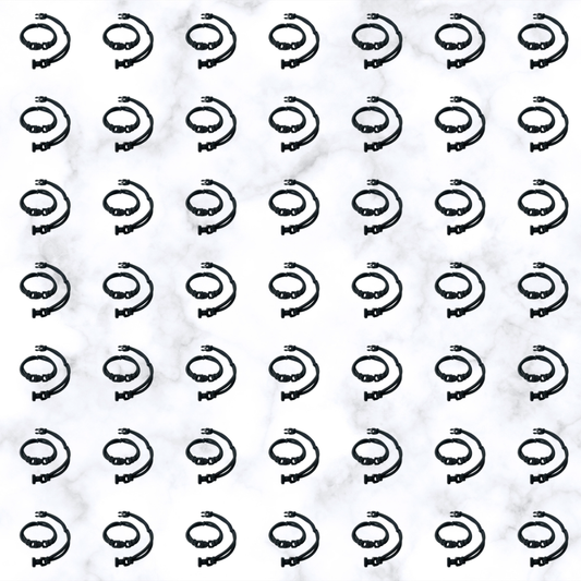 Grid of black Buckle Hair Tie elastics on marble, 100-pack bulk team pack for cheer, gymnastics, volleyball, track, and running