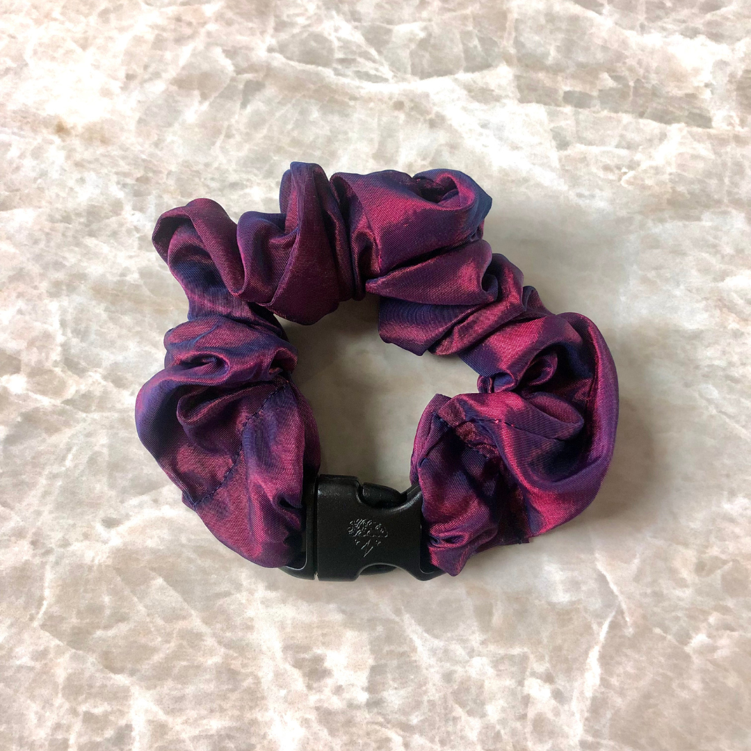 Astral Fire Buckle Scrunchie in metallic red and blue with its quick-release buckle