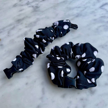 Black polka dot Buckle Scrunchie beside an open one with the buckle unclipped