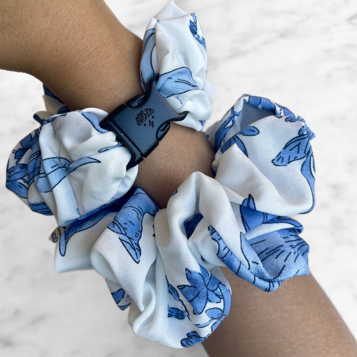 Blue magnolia floral print detail on the jumbo Buckle Scrunchie
