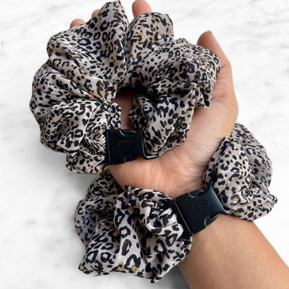 Leopard print Buckle Scrunchie worn on the wrist like a bracelet with a second in hand