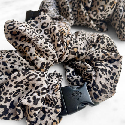 Close view of the leopard print chiffon and navy buckle on a Buckle Scrunchie