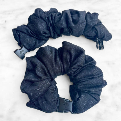 Black glitter Buckle Scrunchie with a quick-release buckle on marble