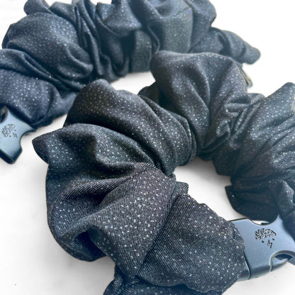 Close view of black glitter fabric and the buckle on a Buckle Scrunchie