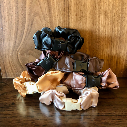 Neutral satin Buckle Scrunchies arranged together on a flat surface