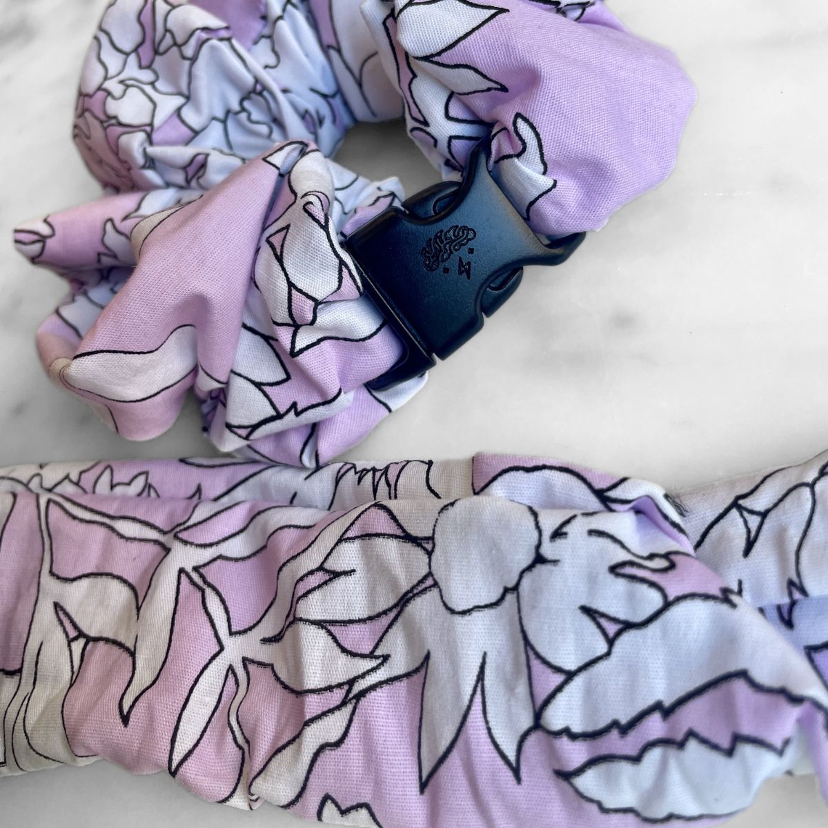 Sketched pink floral print detail on the jumbo Buckle Scrunchie