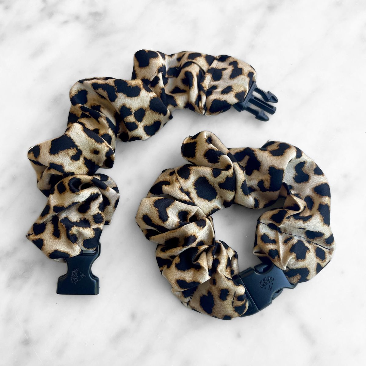Prowl Leopard Buckle Scrunchie in a brown and black leopard print