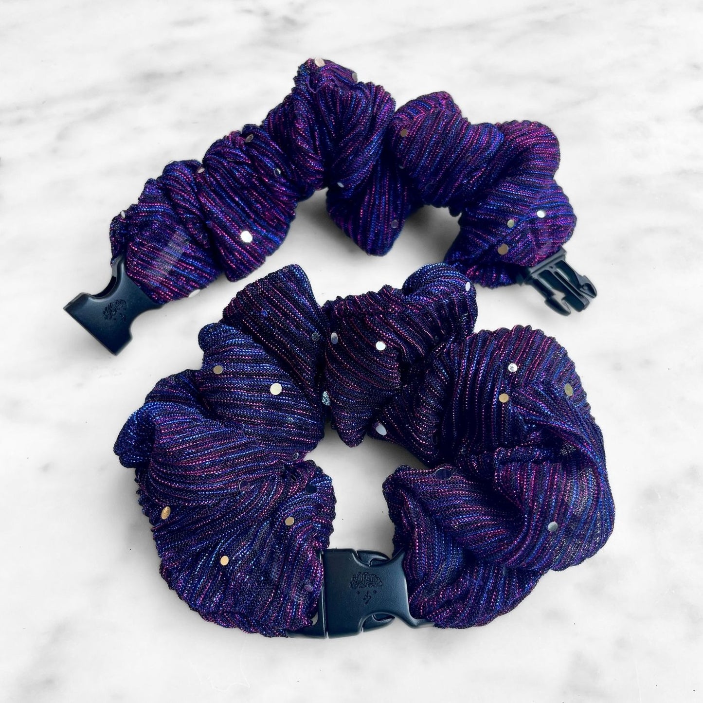 Purple pleated Buckle Scrunchie with iridescent dots and a navy quick-release buckle