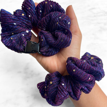 Purple sparkle Buckle Scrunchie held in hand with a second worn on the wrist