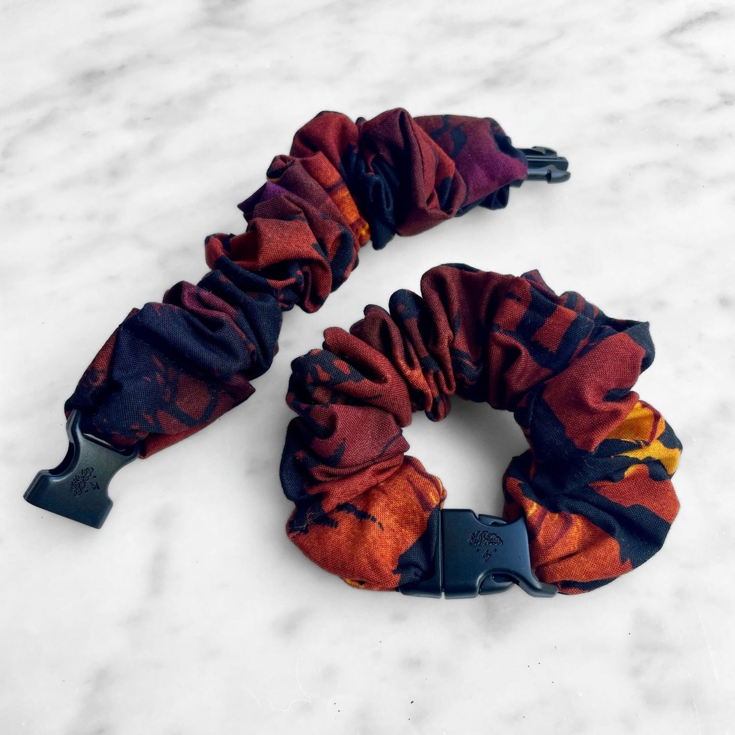Dark red and black abstract print Buckle Scrunchie with a black quick-release buckle