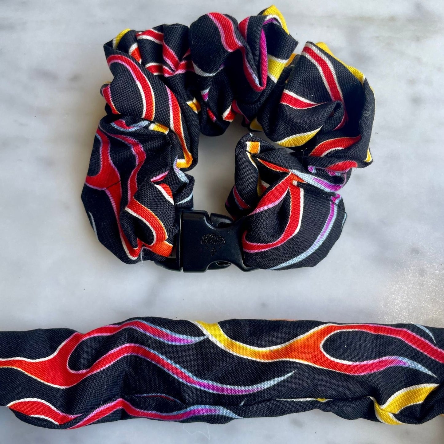 Ribbon swirl print Buckle Scrunchie shown fastened and opened flat side by side