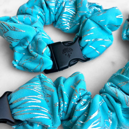Turquoise southwest geometric print fabric detail on the Buckle Scrunchie
