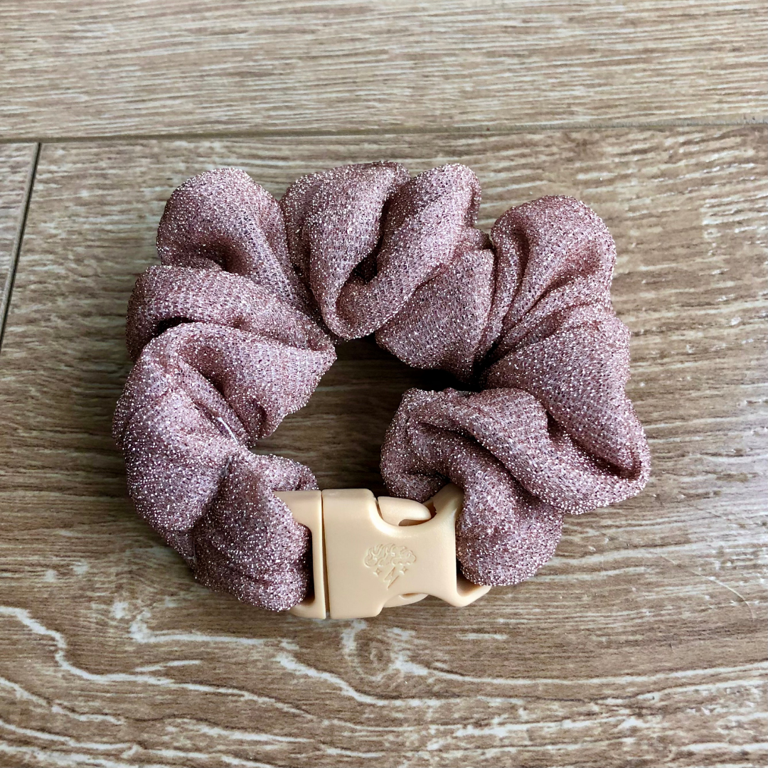 The Maria Buckle Scrunchie in glitter pink blush with its quick-release buckle